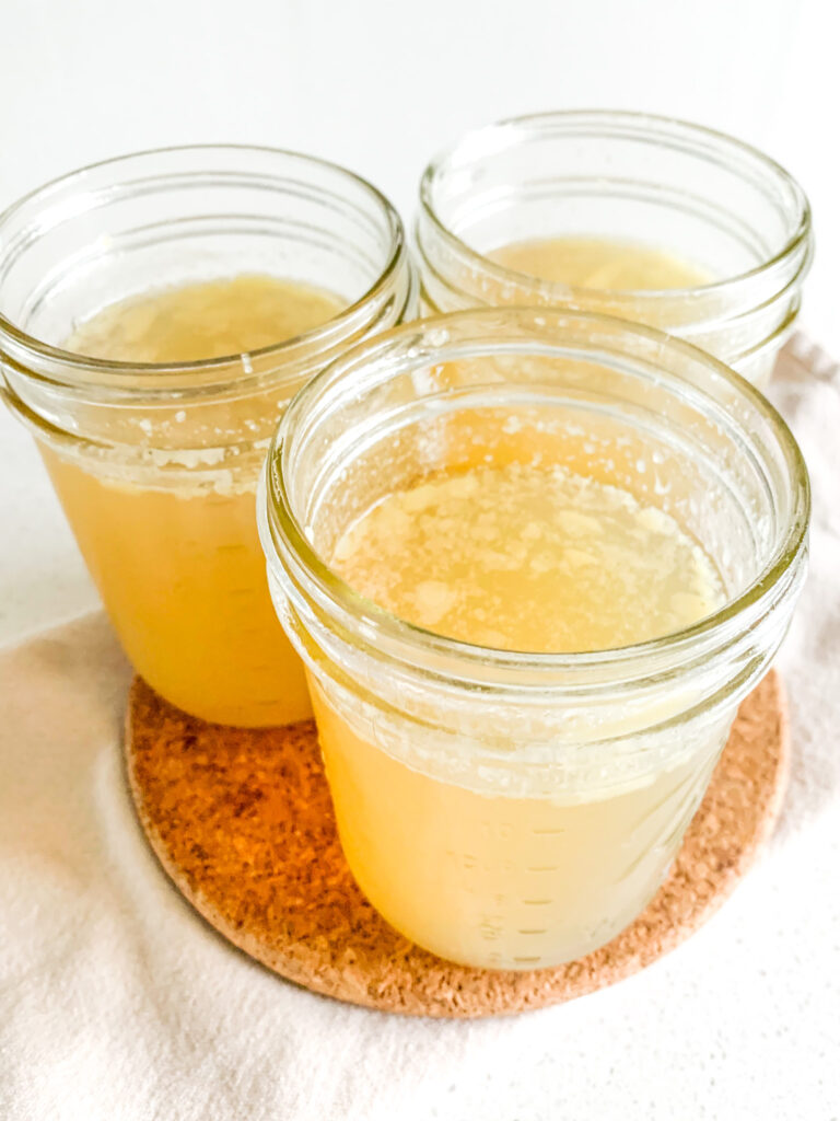 freshly cooked slow cooker chicken stock with rotisserie chicken