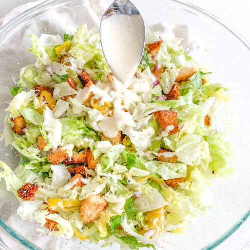 freshly made Italian chopped salad with dressing being added in