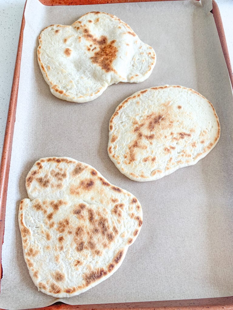 naan bread on pan ready to be made into pizza