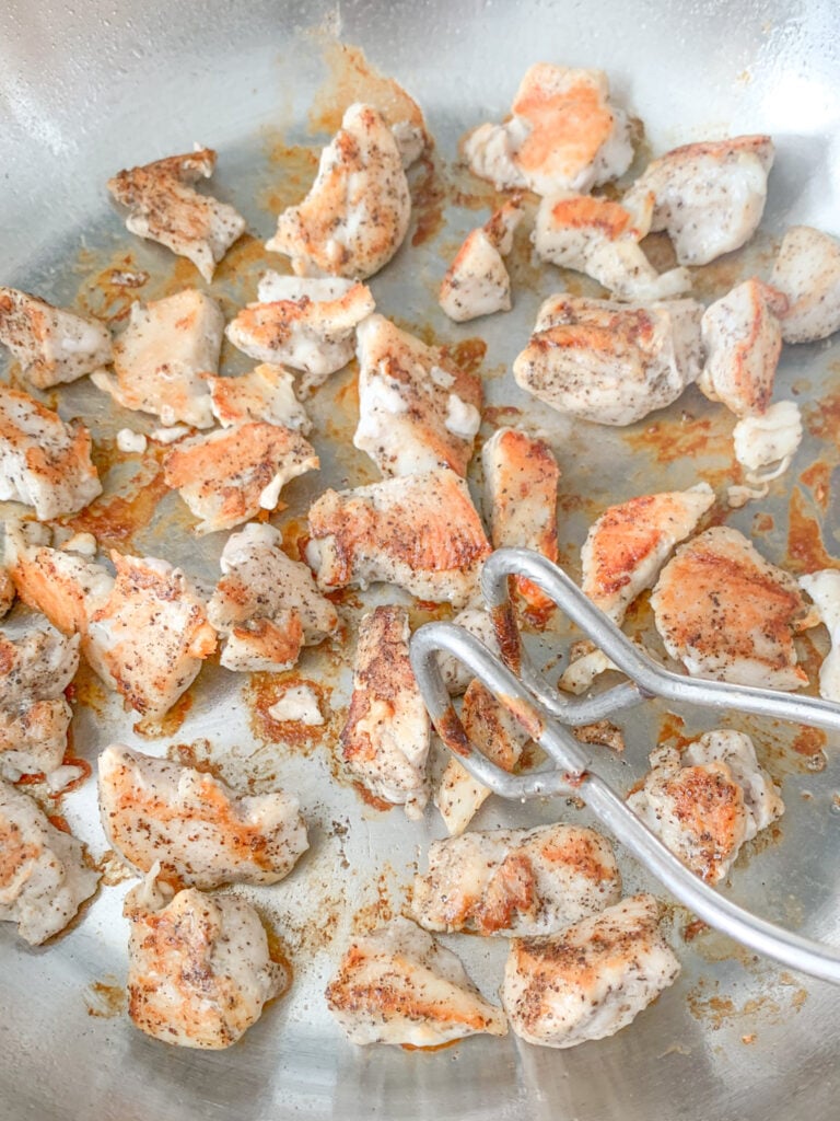 flipping pan seared chicken to cook other side