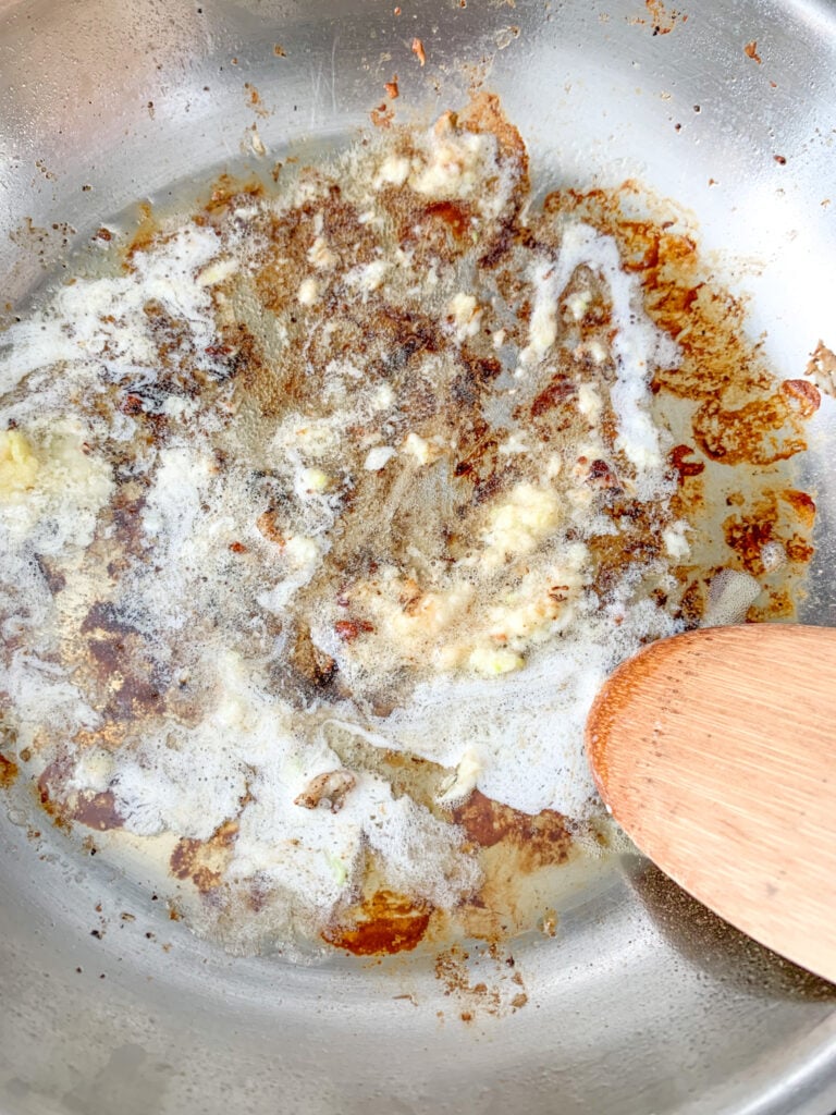 cooking butter and fresh garlic in skillet