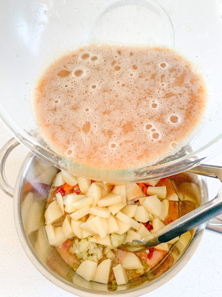 adding stew base into the pot