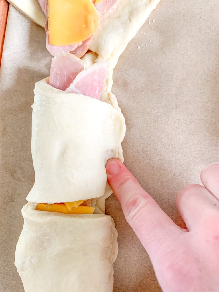 sealing ham and cheese roll ups after rolling