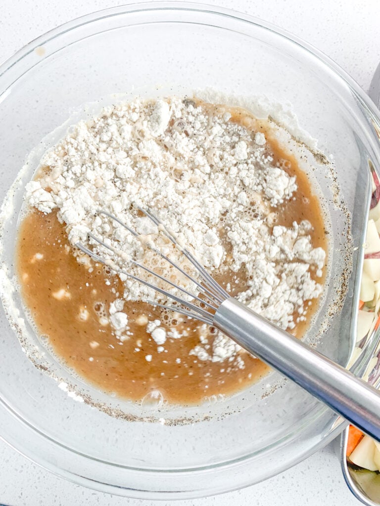 whisking stew base with flour for thickening