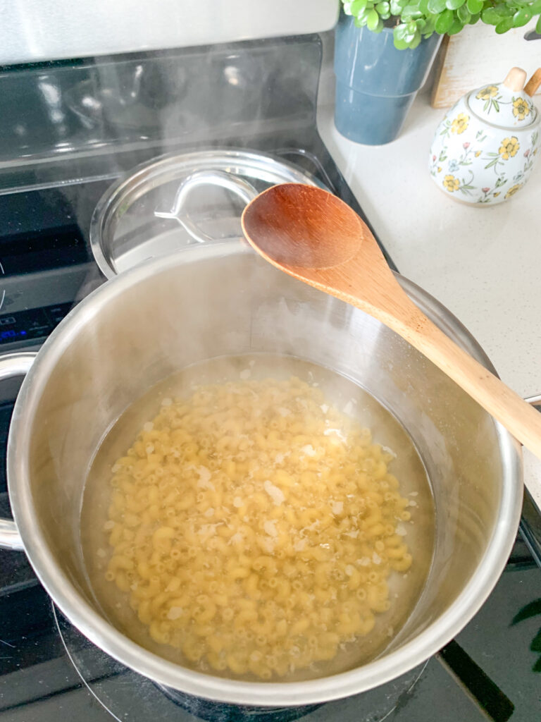cooking elbow pasta on the stovetop for mac and cheese