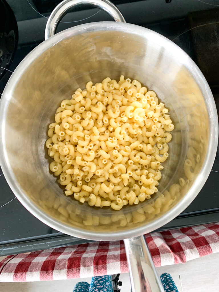 drained elbow pasta ready for mac and cheese sauce