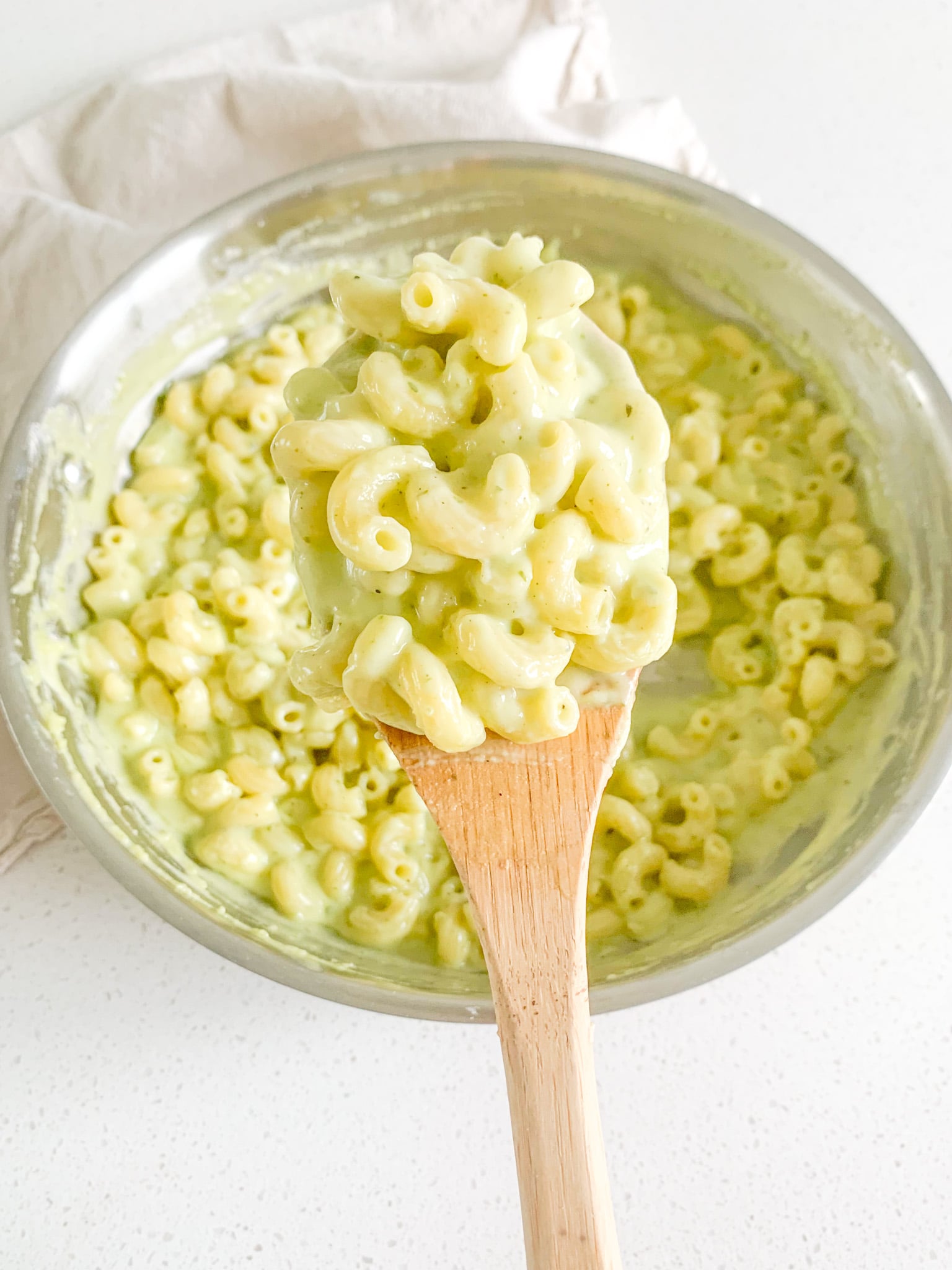 freshly made pesto mac and cheese getting served