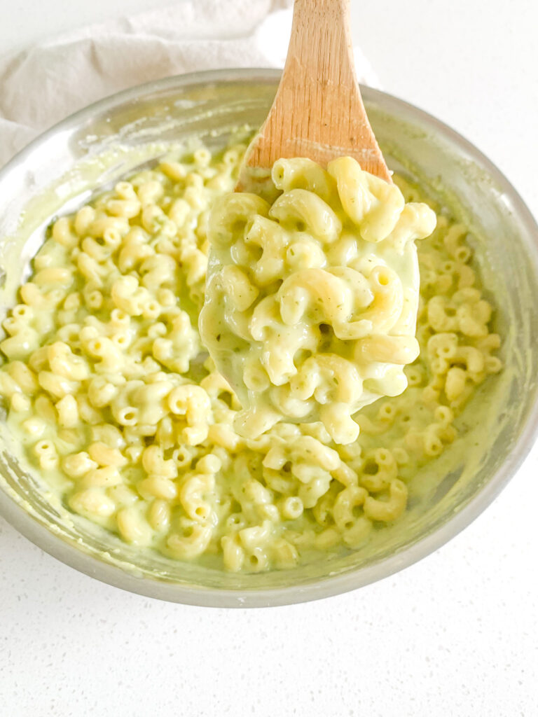 freshly made pesto mac and cheese getting served