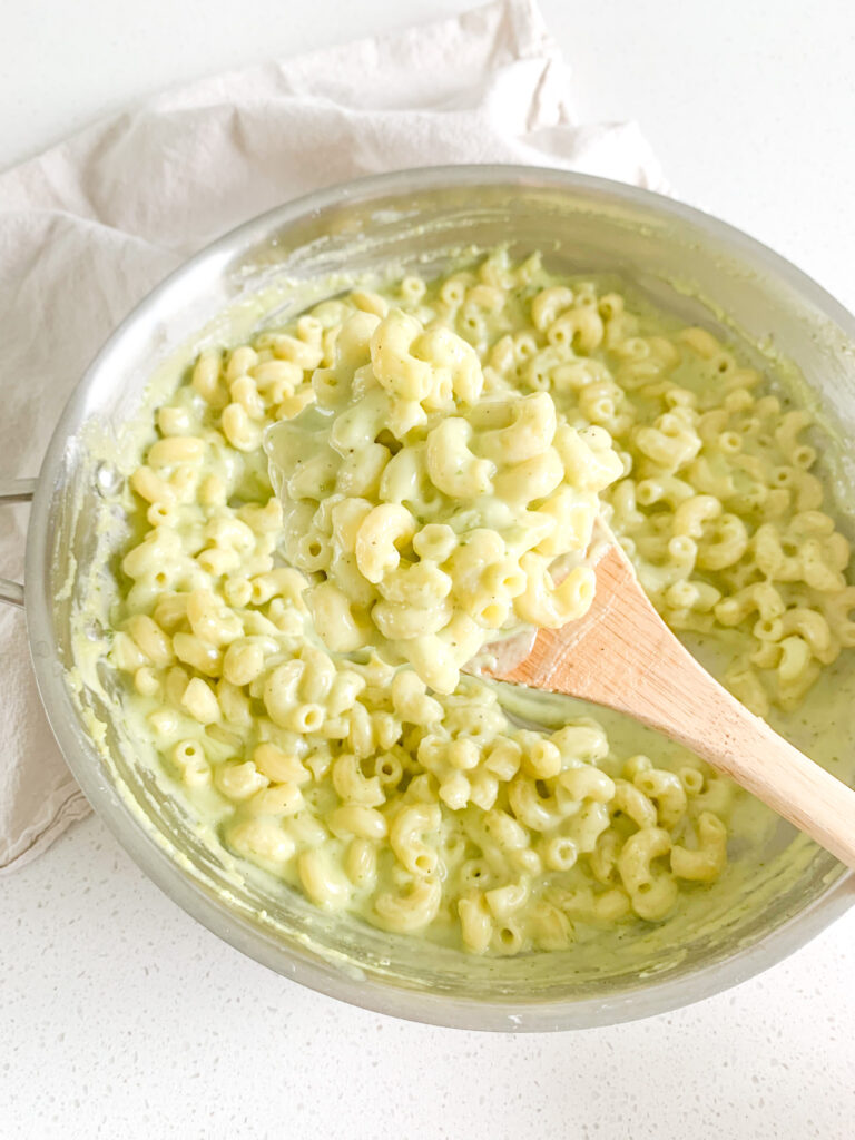 freshly made pesto mac and cheese getting served