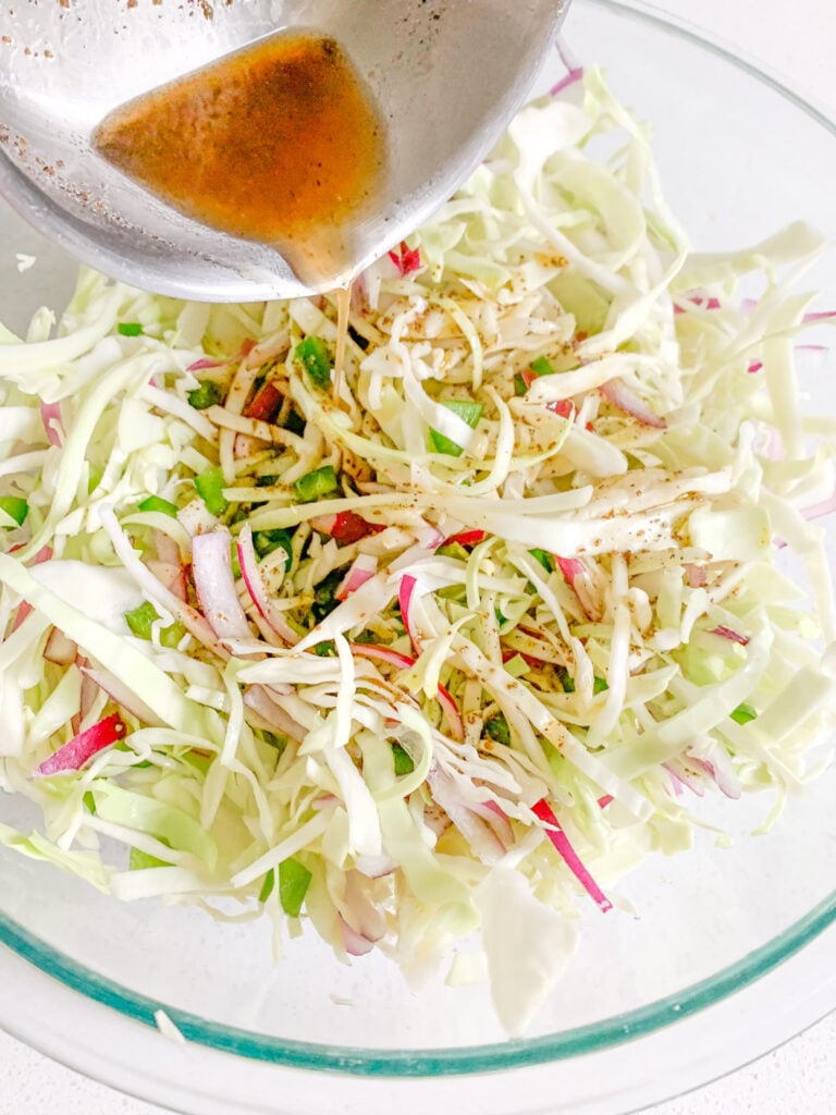 vinegar mix getting added to slaw