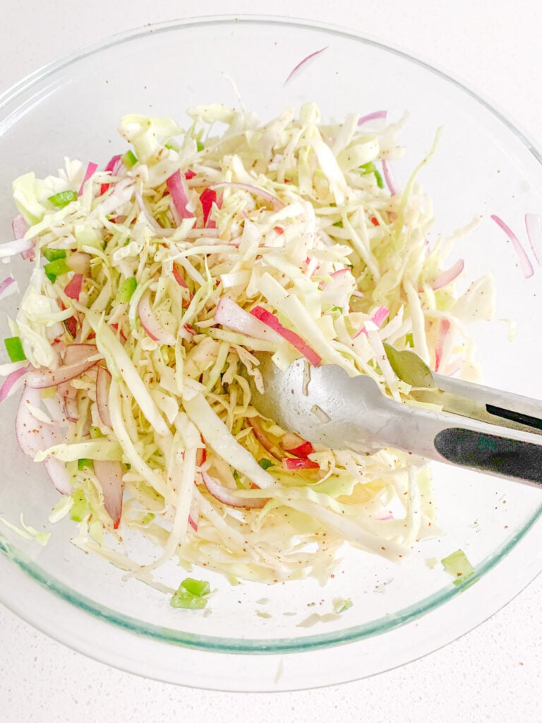 tossing slaw in vinegar mix
