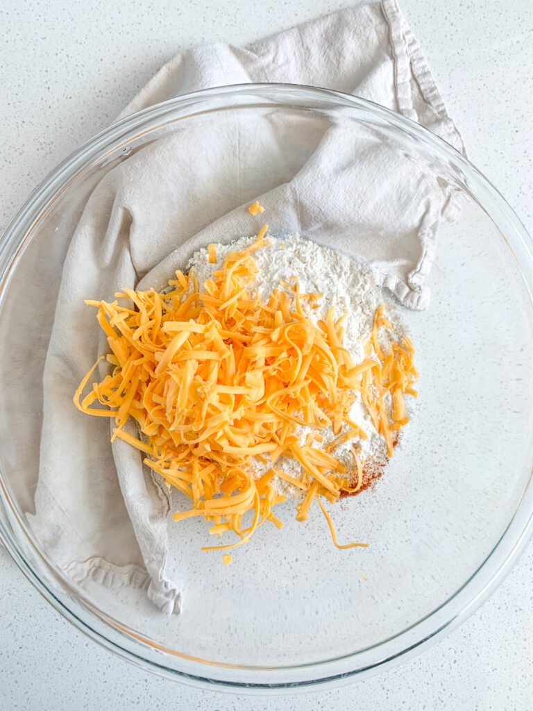 dry ingredients added to a bowl for cheese straws