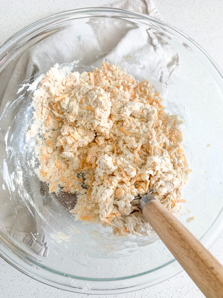 mixing cheese straw dough in a bowl