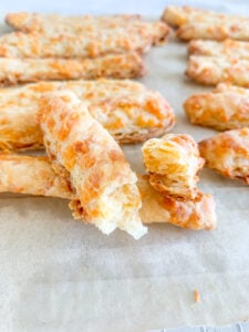 freshly baked sourdough southern cheese straws broke in half