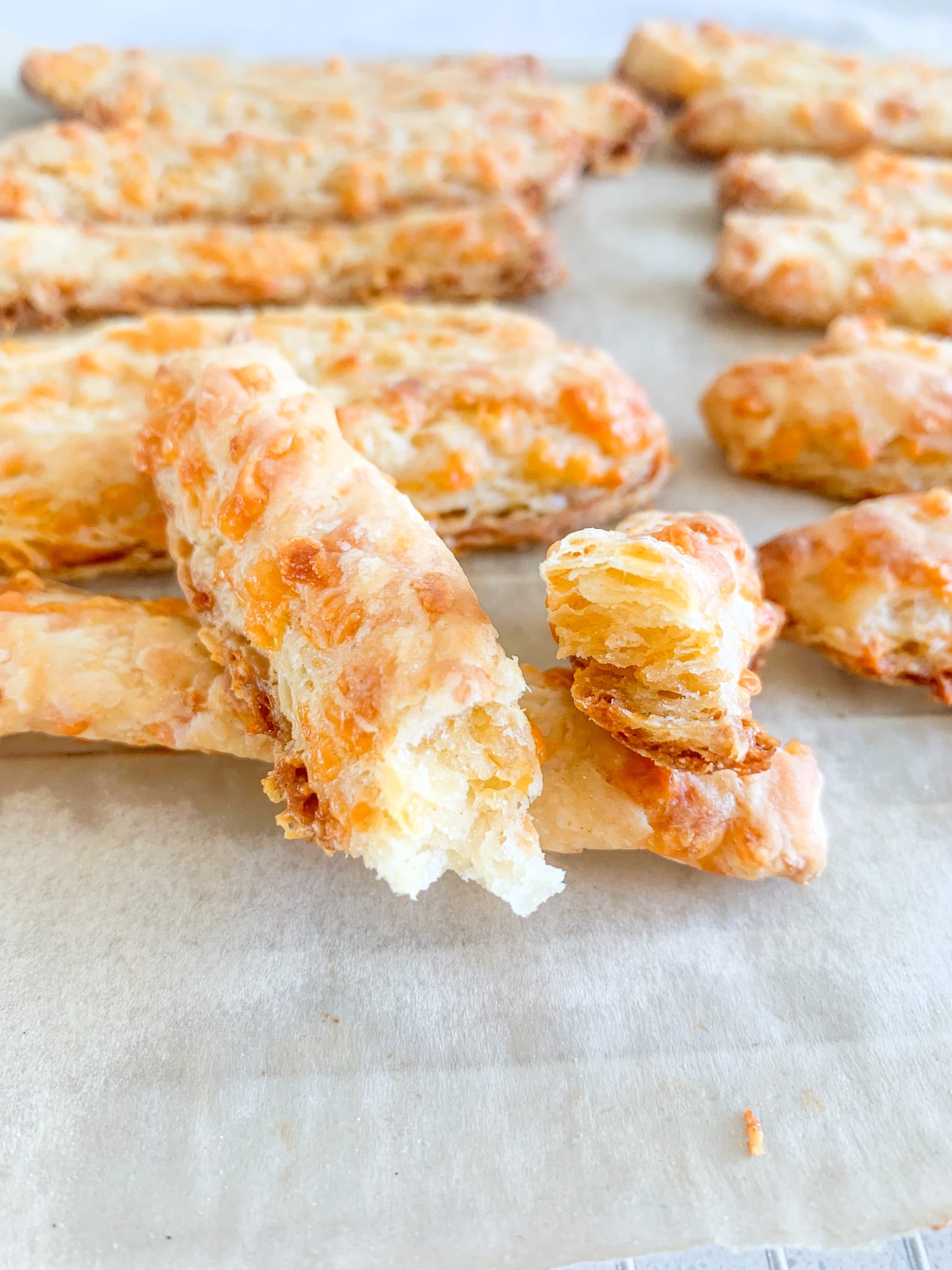 freshly baked sourdough southern cheese straws broke in half
