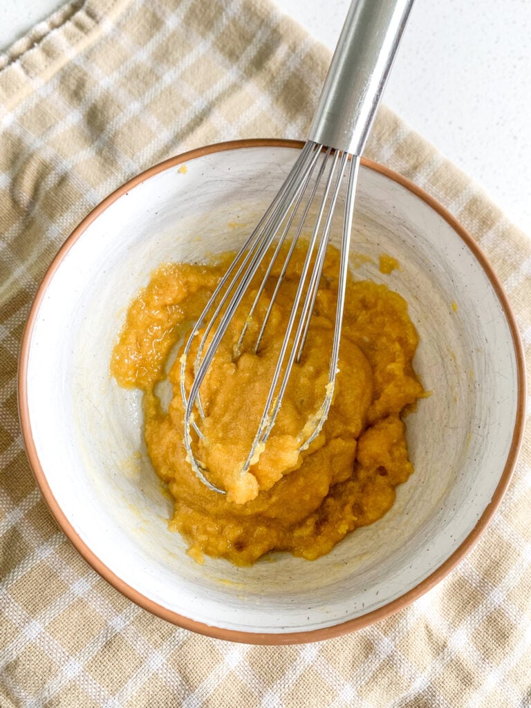whisking egg yolks and other ingredients for base of vanilla pudding