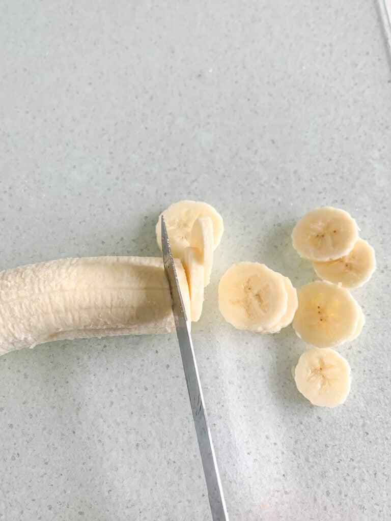 slicing banana to make banana pudding