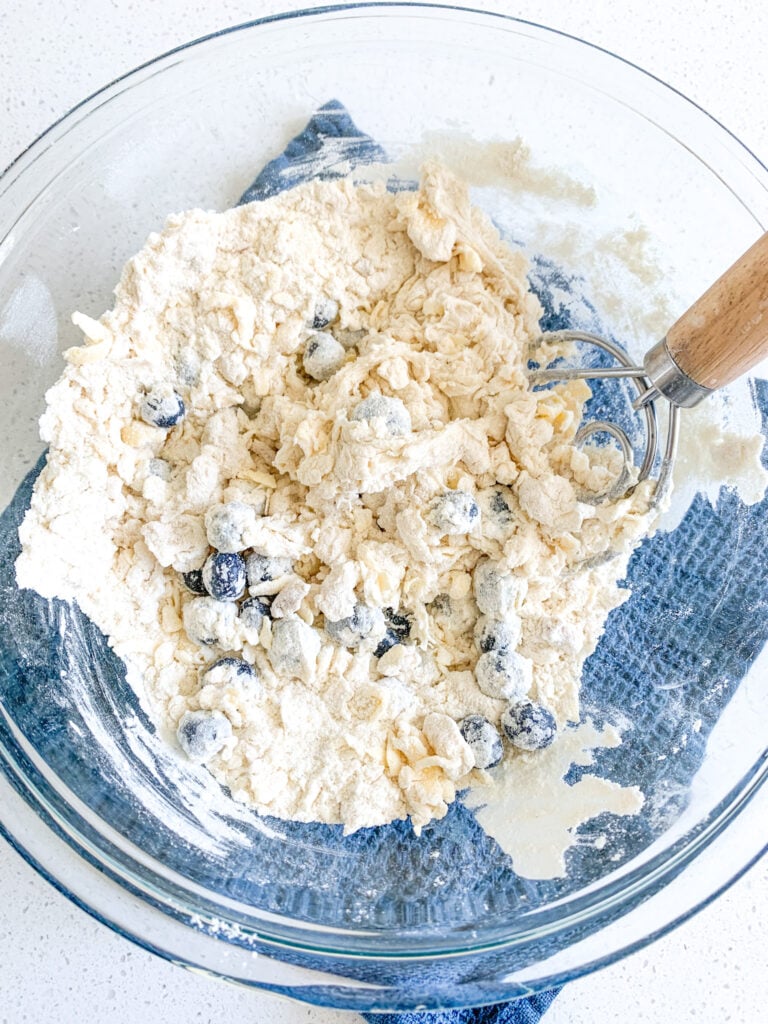 mixing ingredients for sourdough blueberry biscuits
