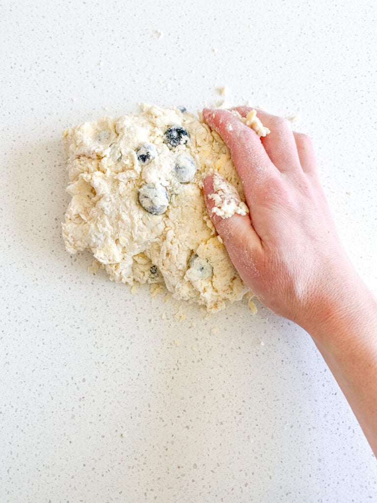 bringing biscuit dough together with hands