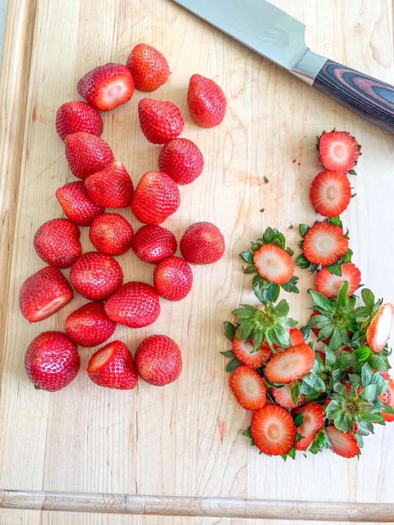 green tops sliced off strawberries