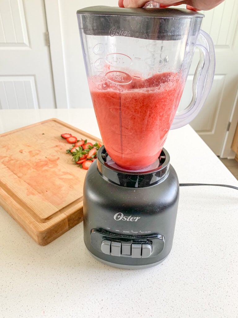 blending strawberries in a blender for jello