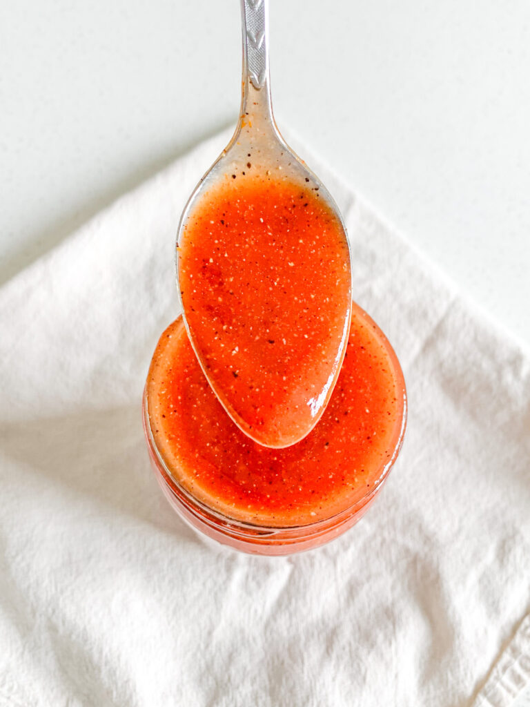 freshly made homemade Tennessee BBQ sauce getting served with a spoon