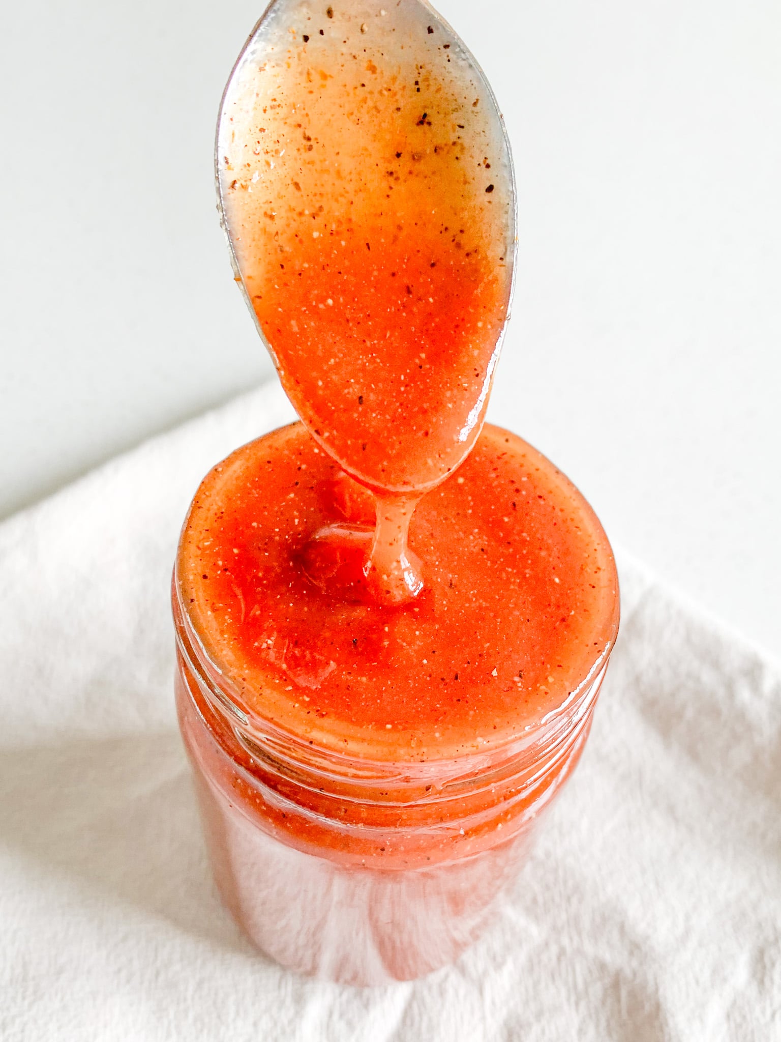 freshly made homemade Tennessee BBQ sauce getting served with a spoon