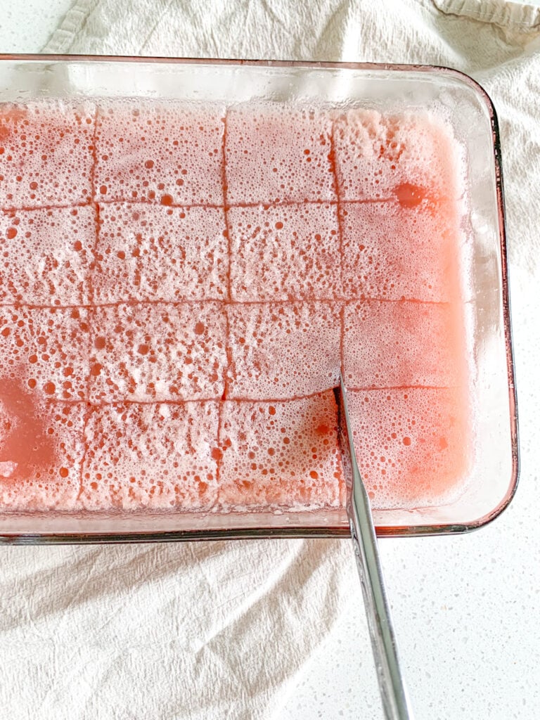 slicing strawberry jello after it's set
