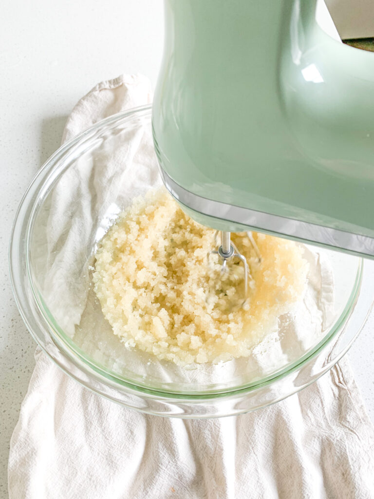 creaming avocado oil and raw cane sugar in a bowl