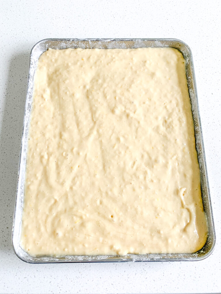 sourdough lemon cake batter in a pan ready to bake