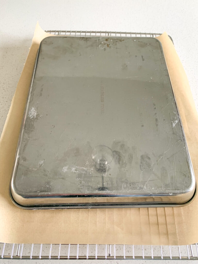 cake flipped upside down ready to be taken out of the pan