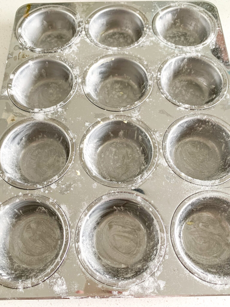 buttered and floured muffin tin
