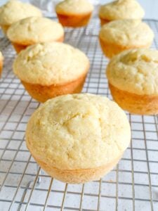freshly baked sourdough corn muffins cooling on a cooling rack