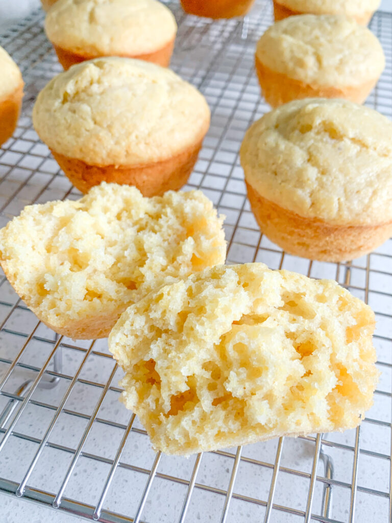 freshly baked sourdough corn muffins cooling on a cooling rack