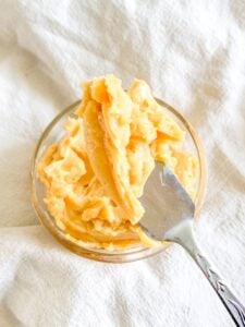 freshly whipped sorghum butter in a bowl getting served with an offset spatula