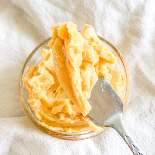 freshly whipped sorghum butter in a bowl getting served with an offset spatula