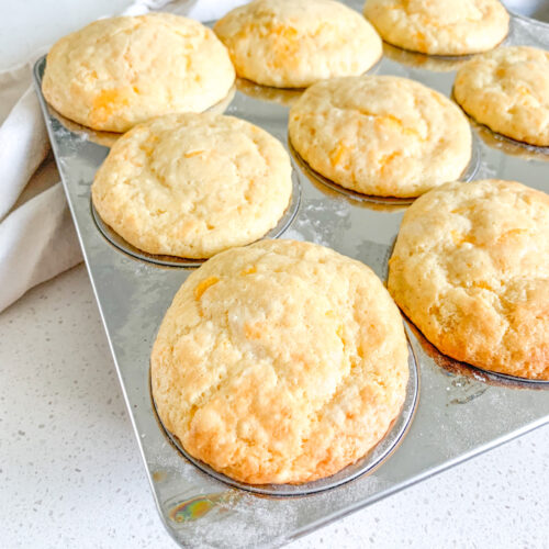 freshly baked sourdough cheddar cheese muffins in the baking tin