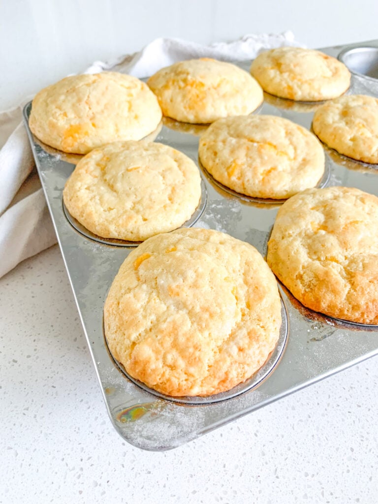 freshly baked sourdough cheddar cheese muffins in the baking tin