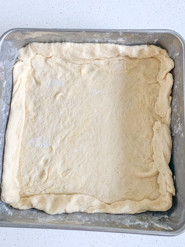 sourdough crescent dough shaped as a crust in pan
