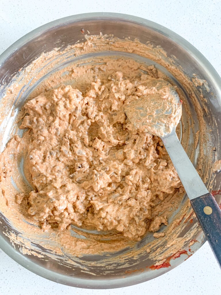 mixing beef filling together in a skillet