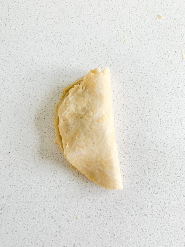 sourdough hand pie dough folded in half over filling