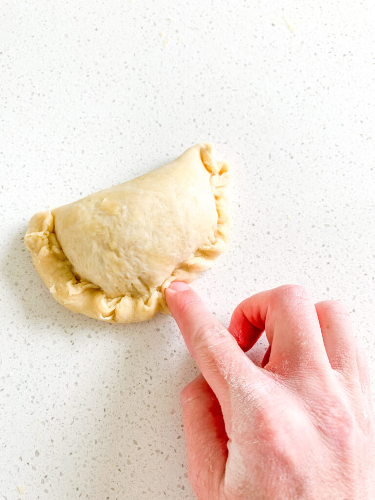 rolling crimped edges of hand pie dough to make them look pretty