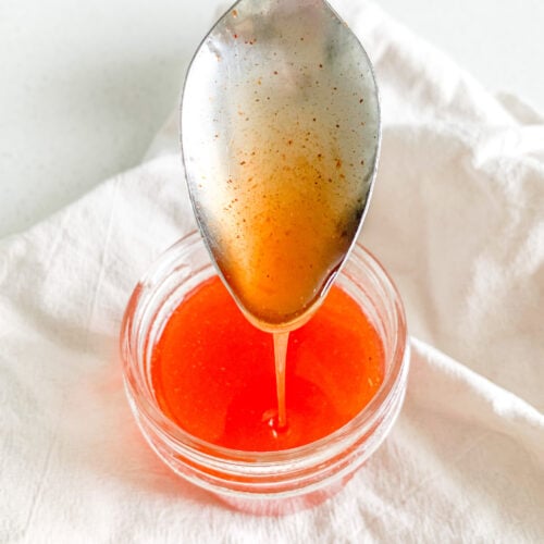 hot honey sauce being served with a spoon