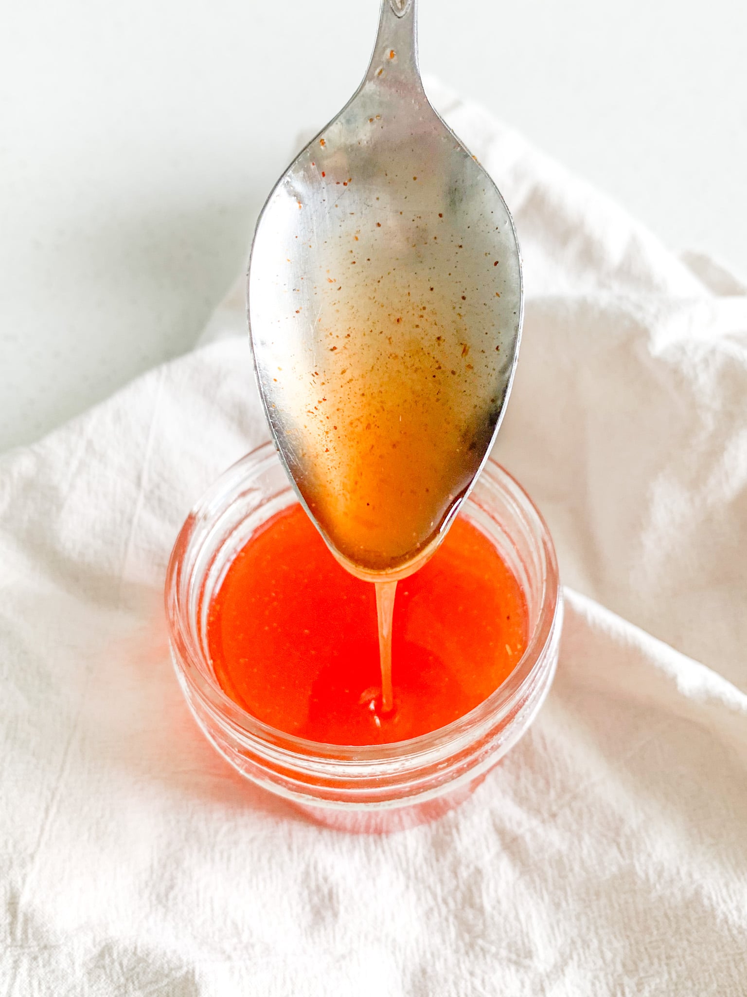 hot honey sauce being served with a spoon