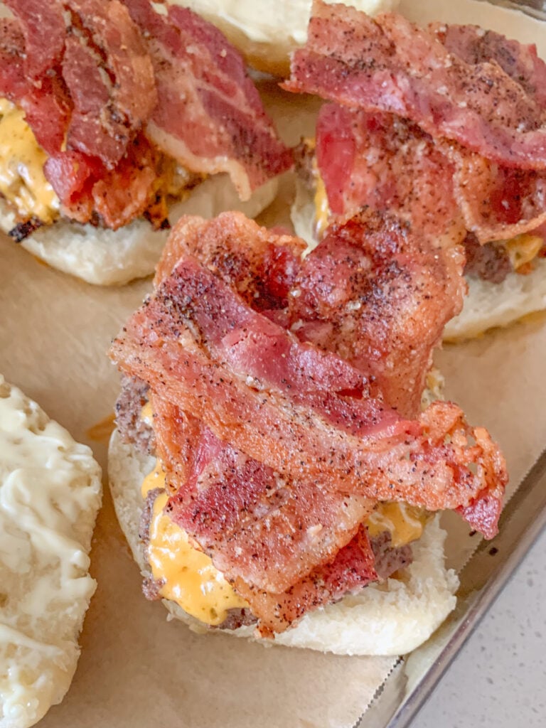 bacon added to burgers on slider buns