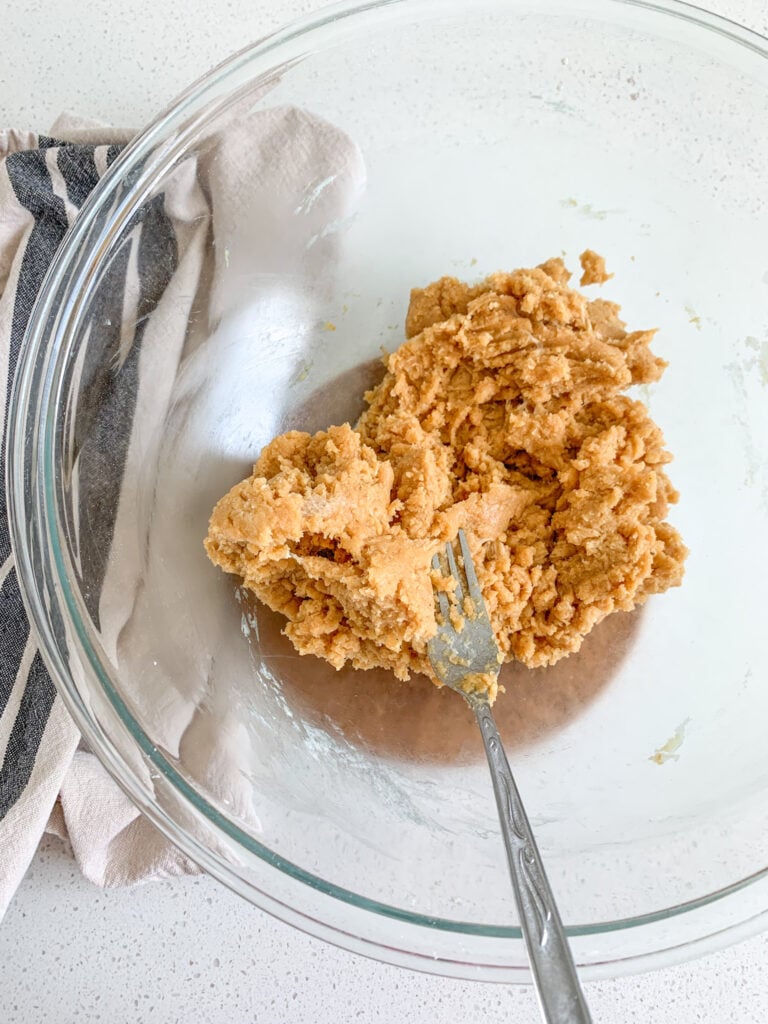 mixing sourdough peanut butter cookie dough in a bowl