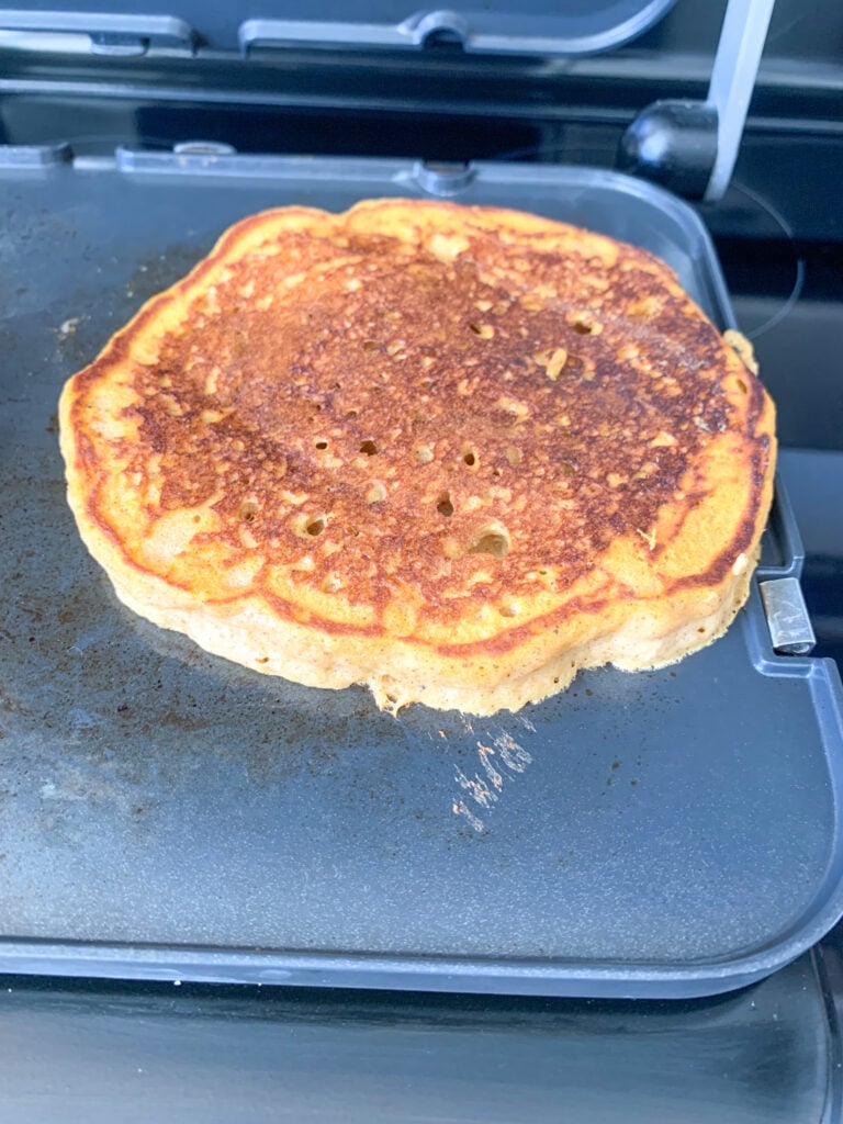 pumpkin sourdough pancake cooking on a griddle