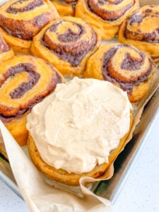 freshly baked and frosted sourdough pumpkin cinnamon rolls
