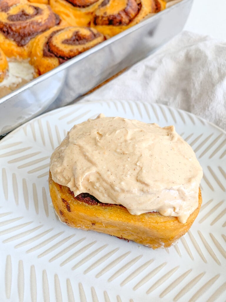 freshly baked and frosted sourdough pumpkin cinnamon rolls