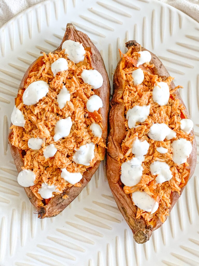 buffalo chicken stuffed sweet potatoes topped with ranch